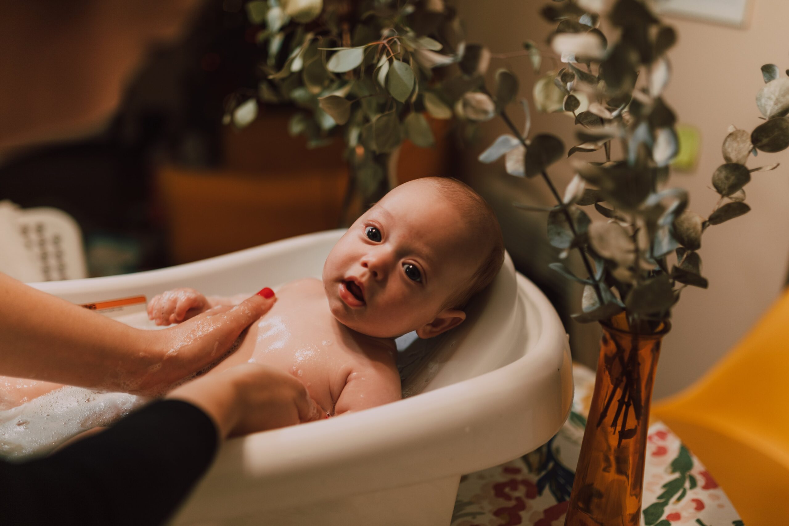 baby showering in a bath tub