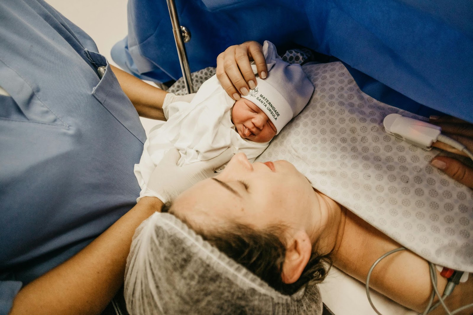  a premature baby being held on her mother’s chest