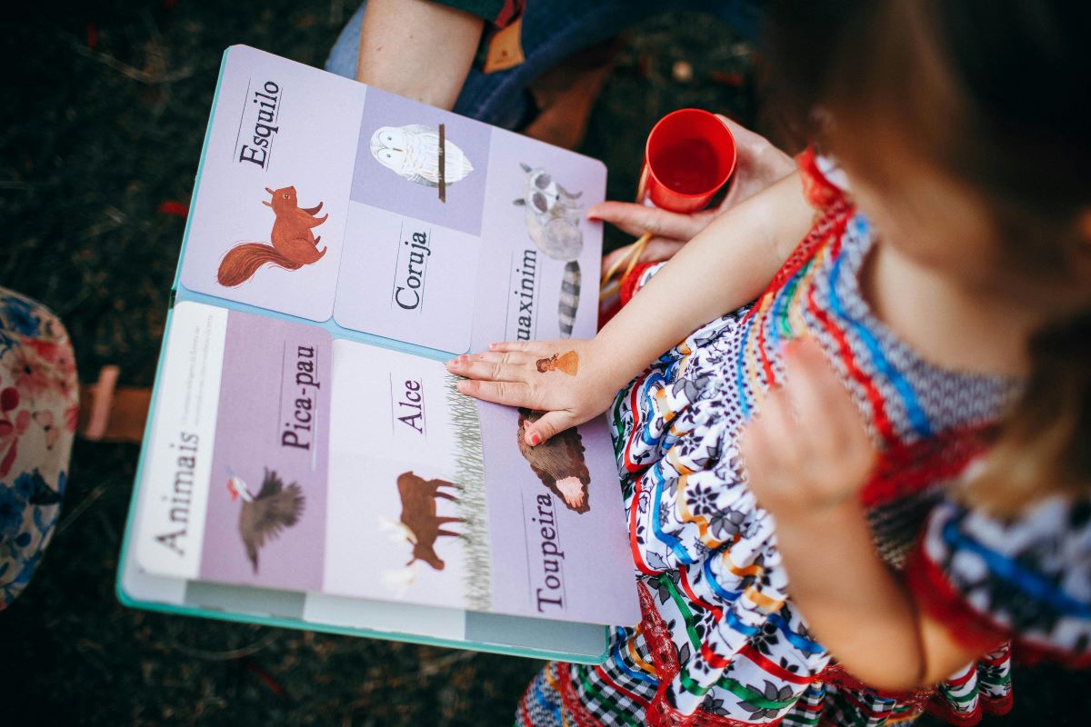 a girl reading a colorful book