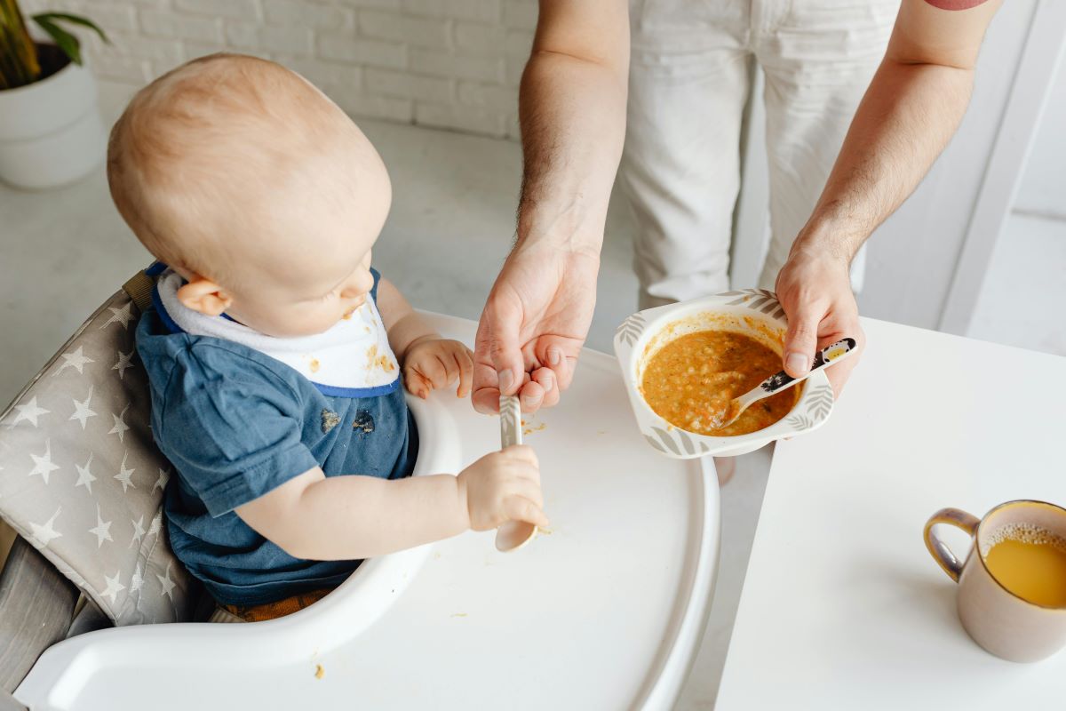 a woman feeding a baby